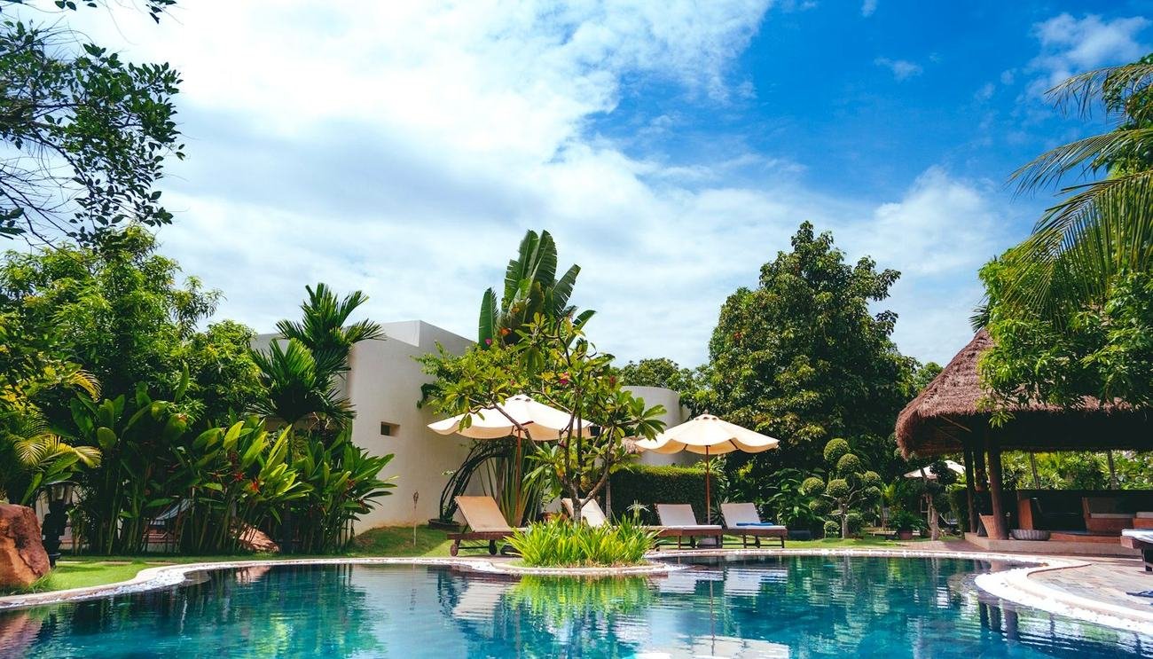 Swimming pool set among palms in a landscaped residential community
